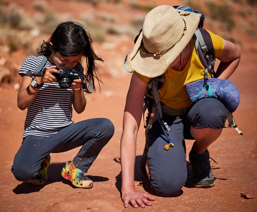 Jen Lumanlan and daughter Carys exploring photography together in a desert landscape