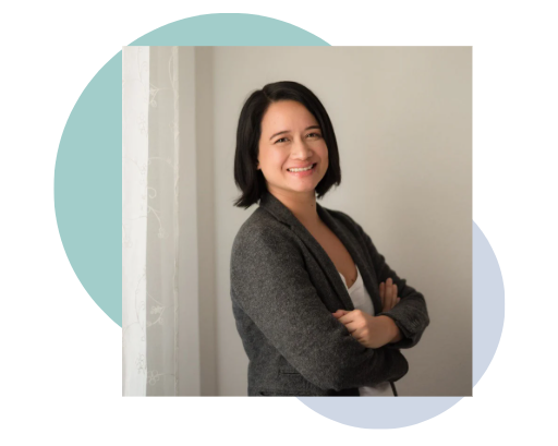 en Lumanlan smiles at the camera wearing glasses and a red patterned sleeveless top