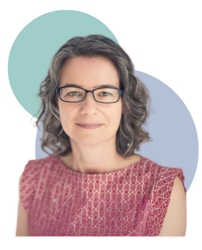 en Lumanlan smiles at the camera wearing glasses and a red patterned sleeveless top