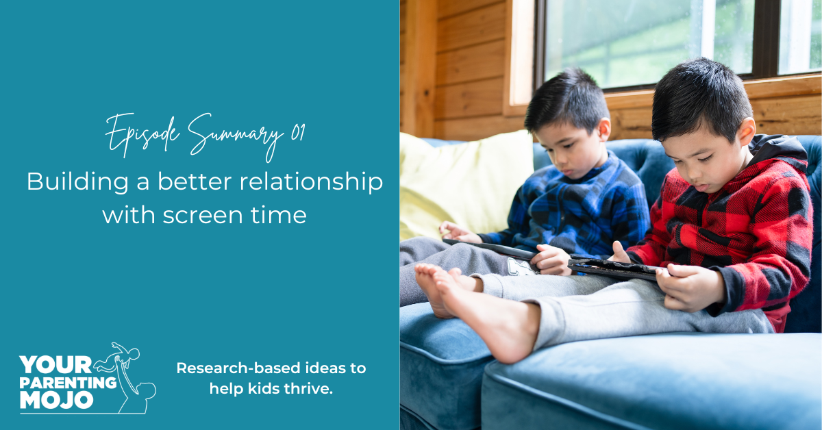 Two young boys in sweaters sit on a blue couch playing handheld gaming devices together