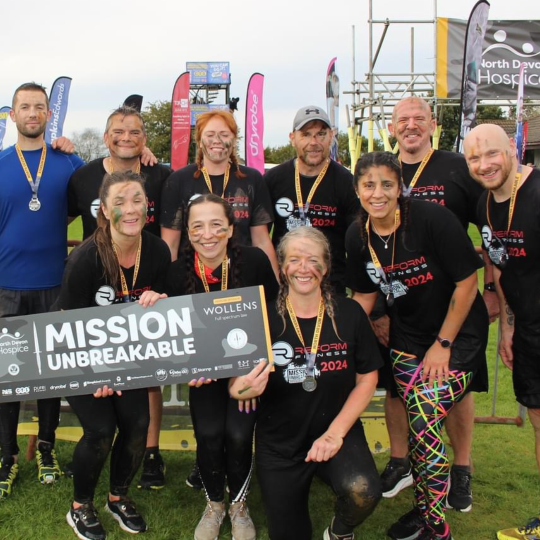 A group of people wearing Reform Fitness tops after completing Mission Unbreakable obstacle course.