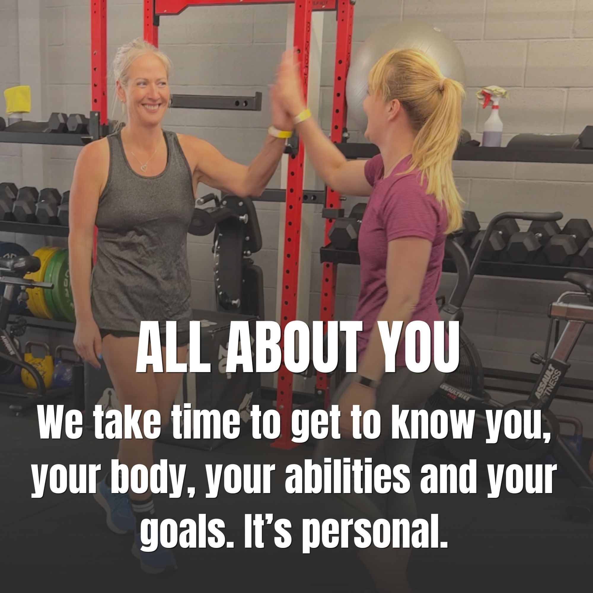 Two clients at Reform Fitness high-fiving after an exercise.