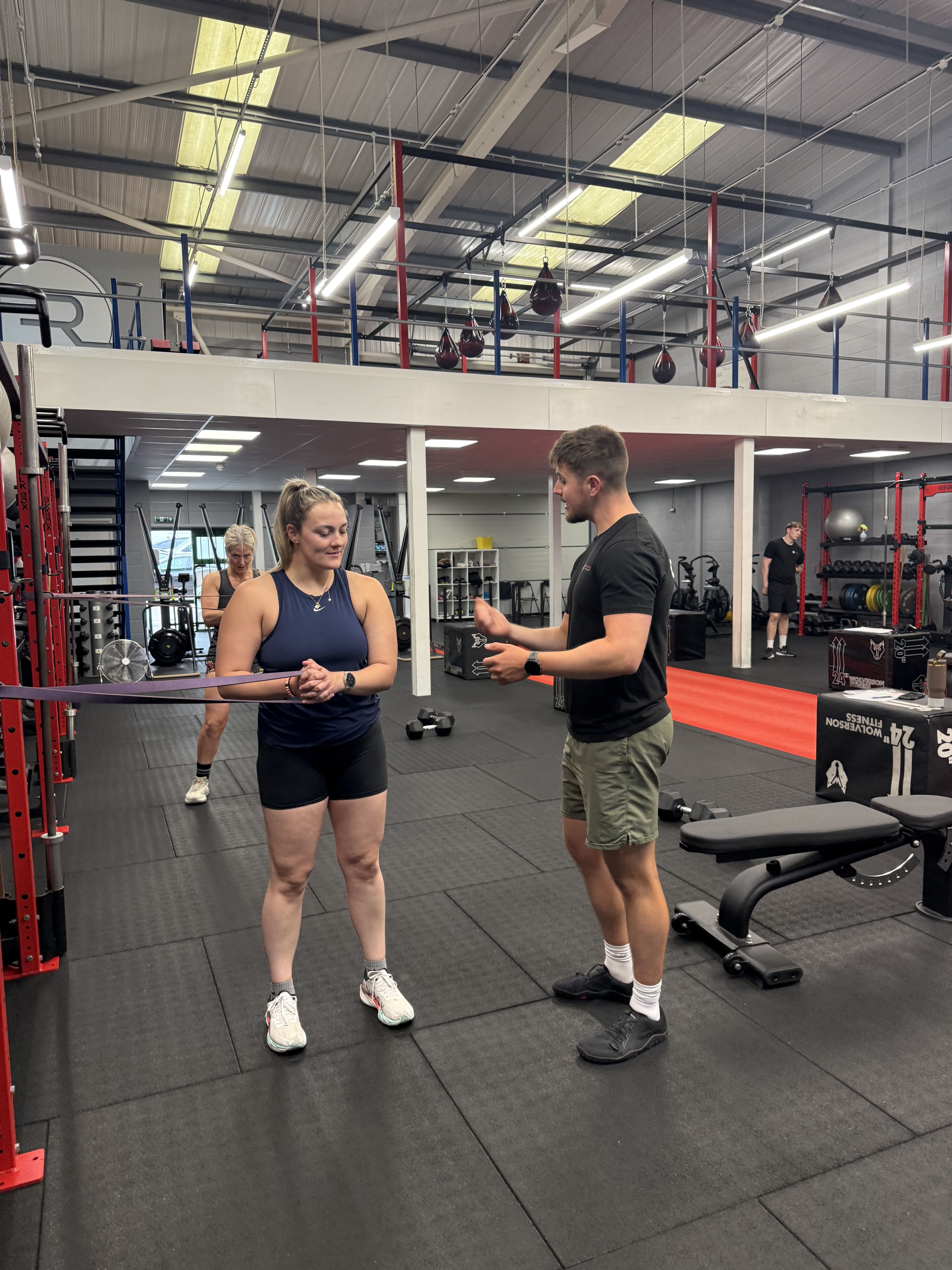 Reform Fitness coach supporting a member