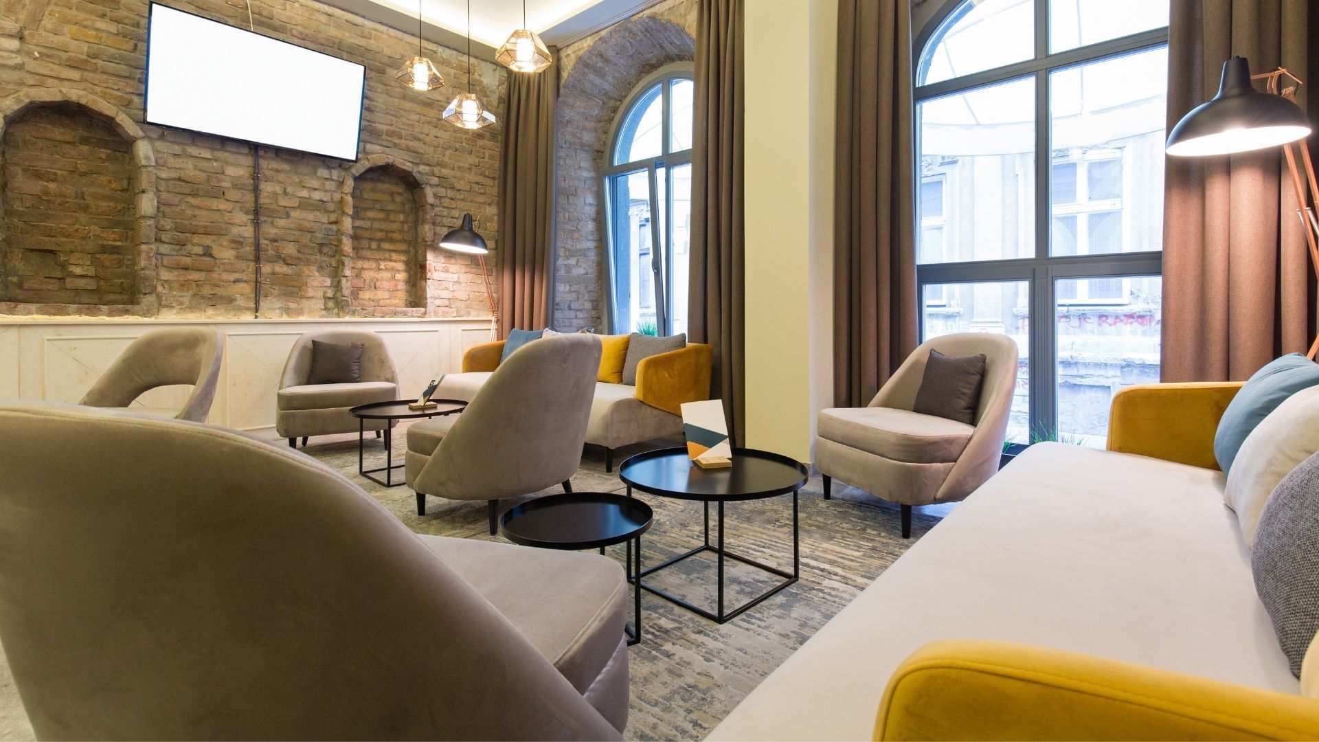 A comfortable and peaceful room with natural light, couches, and lounge chairs.