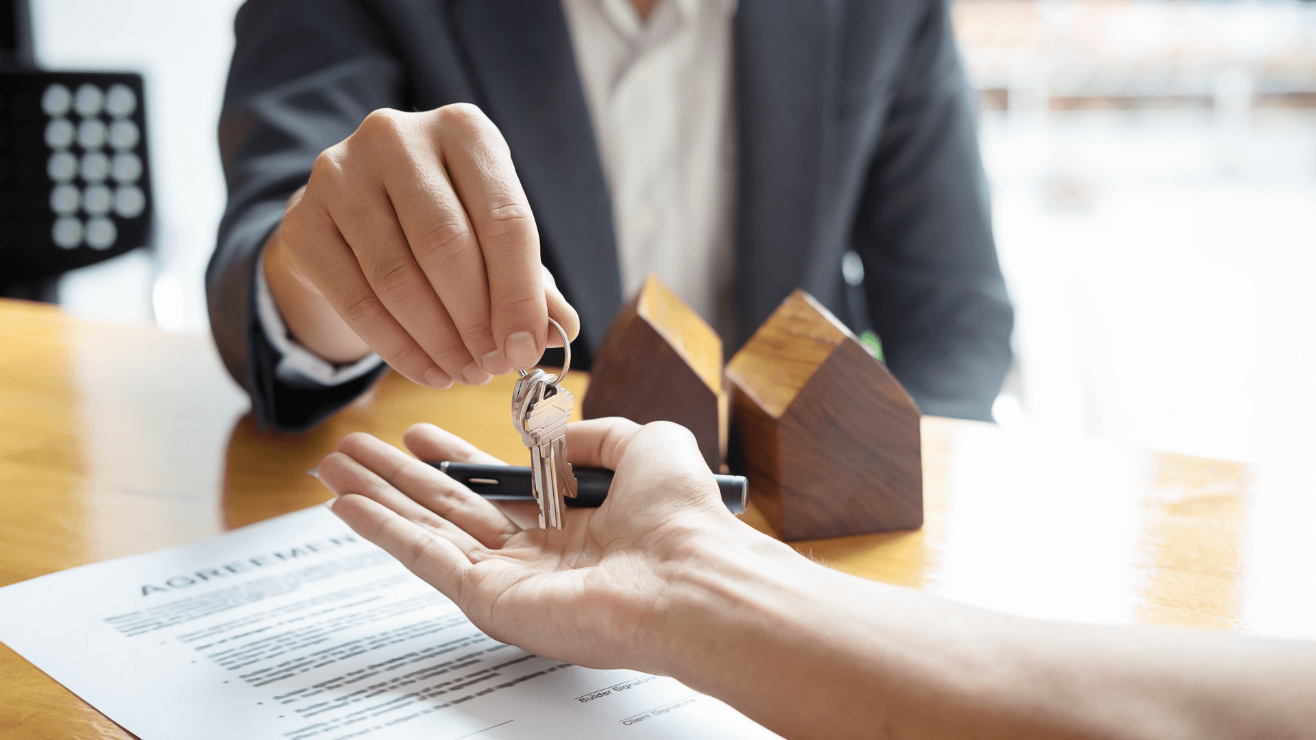 Real estate agent handing keys to a buyer in Australia’s property market.