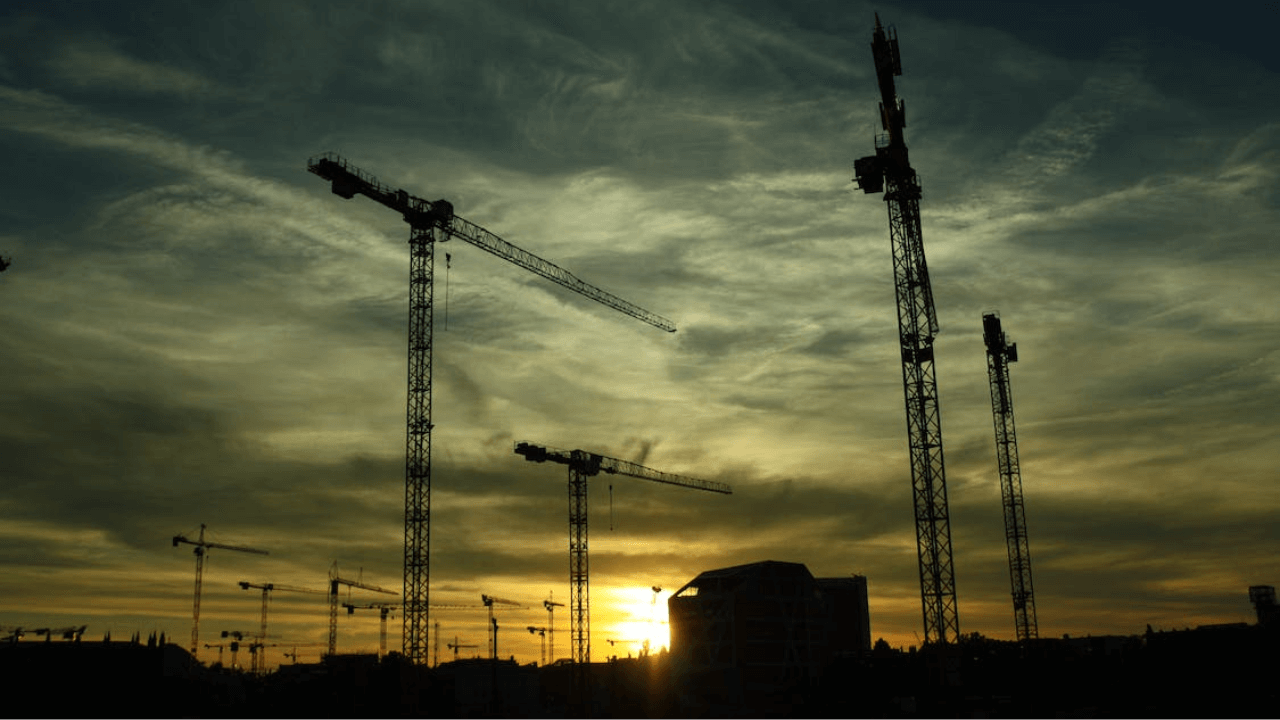 Silhouette of construction cranes highlighting the downturn in building approvals.