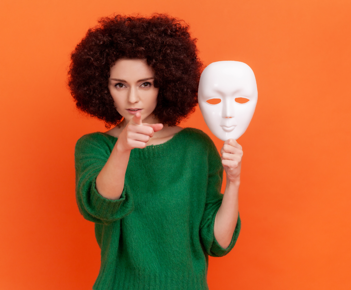 Woman holding a mask – symbol of confidence and authenticity in business