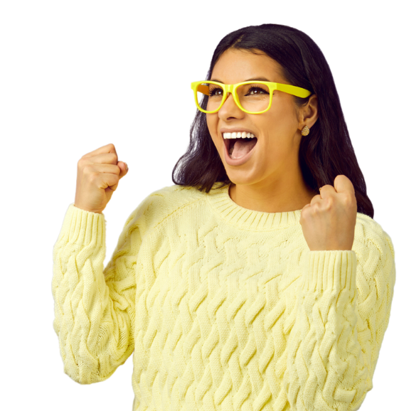 Woman in pastel yellow knitted jumper with summer yellow glasses holding her hands up, closed fists with excitement