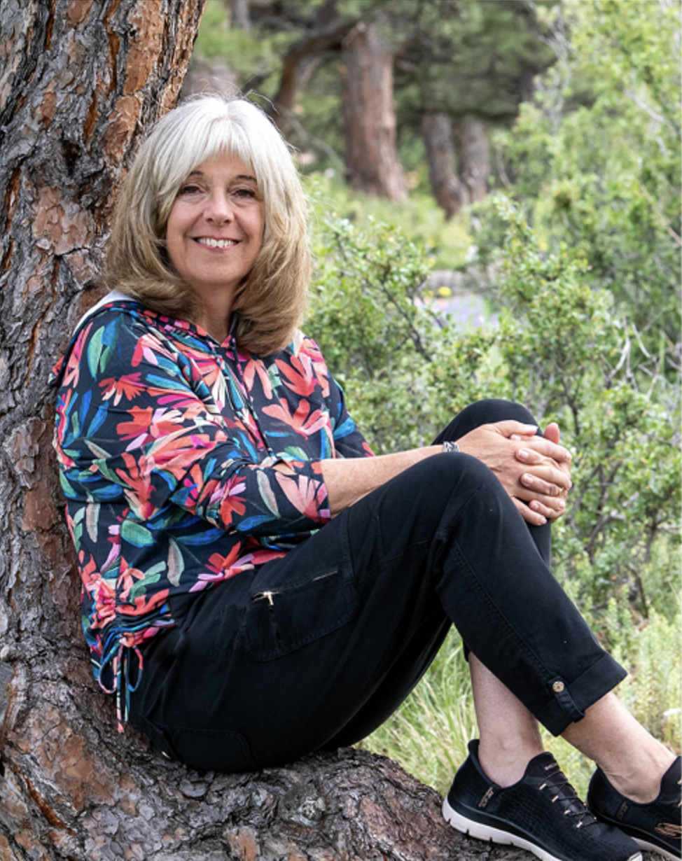 Beth Marvel, Certified Nature-Based Integration Coach and ACC candidate, seated outdoors against a tree