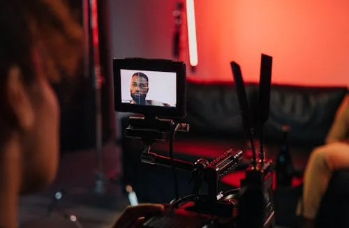 A person capturing footage on camera.