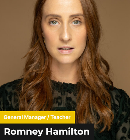 Romney Hamilton - A fierce lady with a long brown hair wearing a black patterned blouse