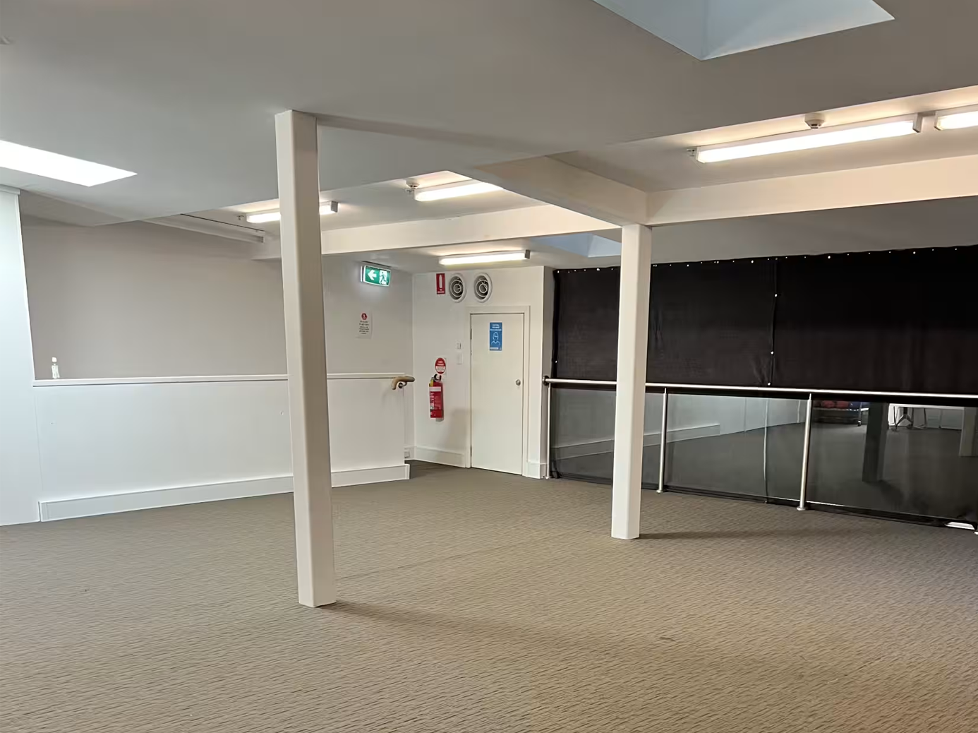 An empty room with a black curtain and white walls - a minimalist space with contrasting colors. Darlinghurst Venue hire