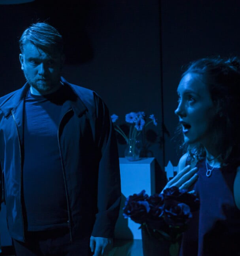 An image of a man and woman standing in a dark room, creating a sense of intrigue and suspense, sydney acting class