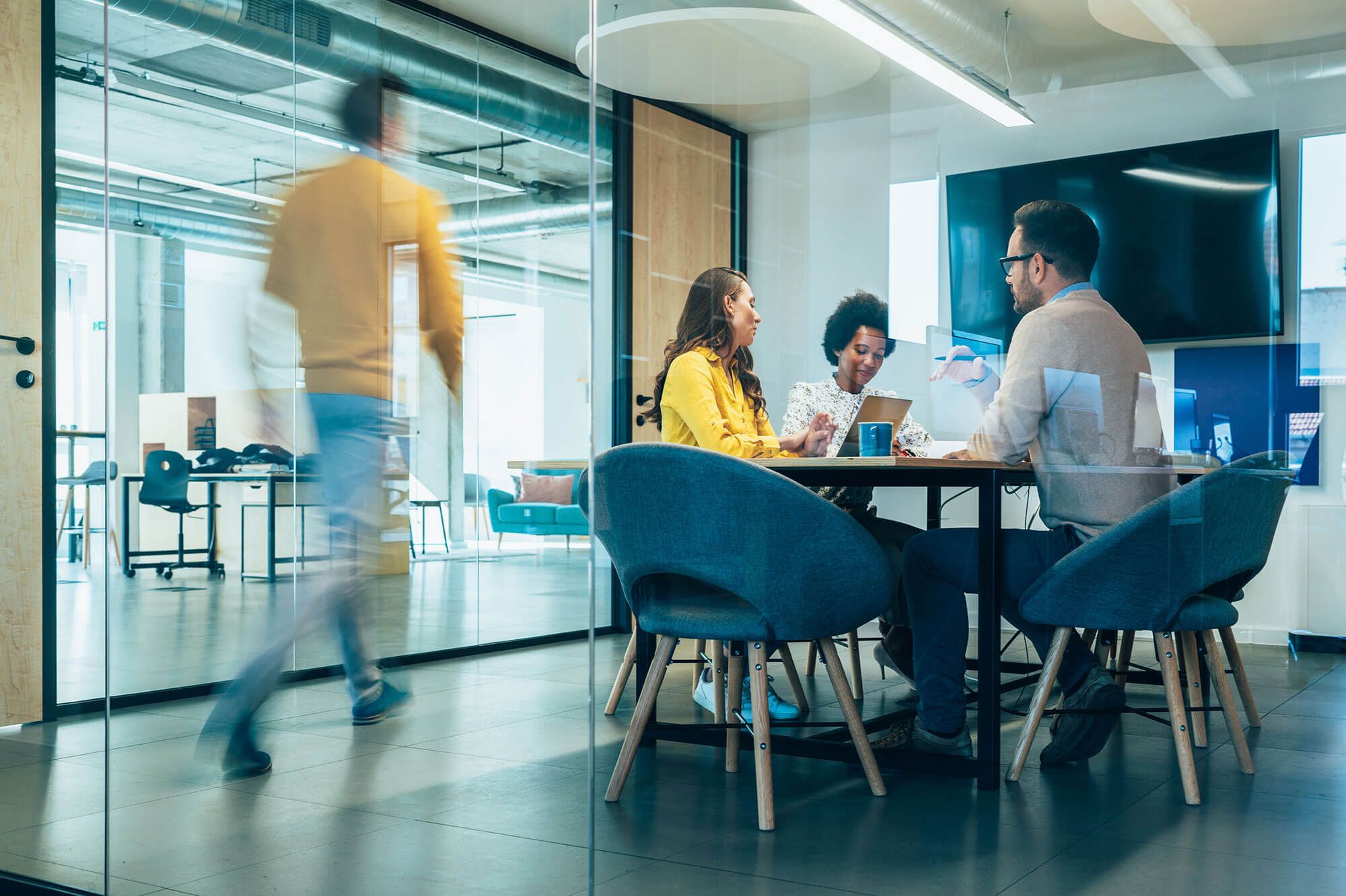 An image of people in a meeting roomhaving a meeting