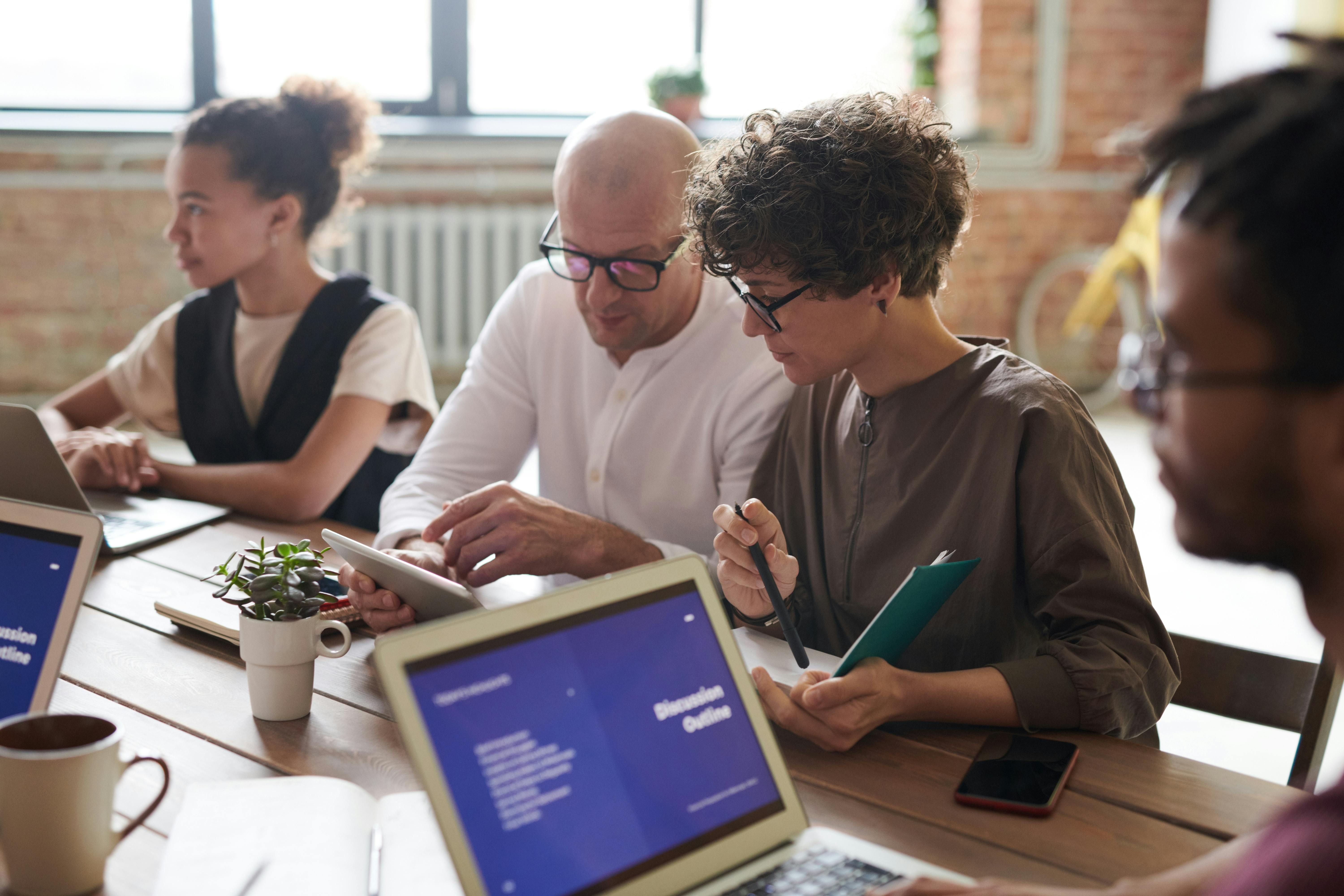 An image of people in a meeting roomhaving a meeting