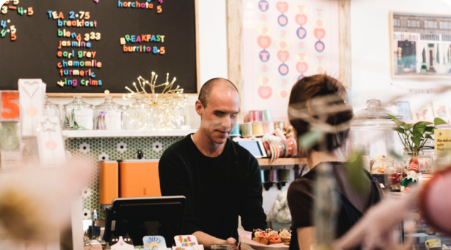 An image of a person at a cash register ringing someone up