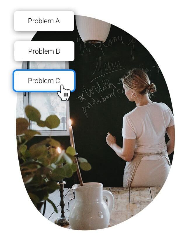 A woman writing on a chalkboard.