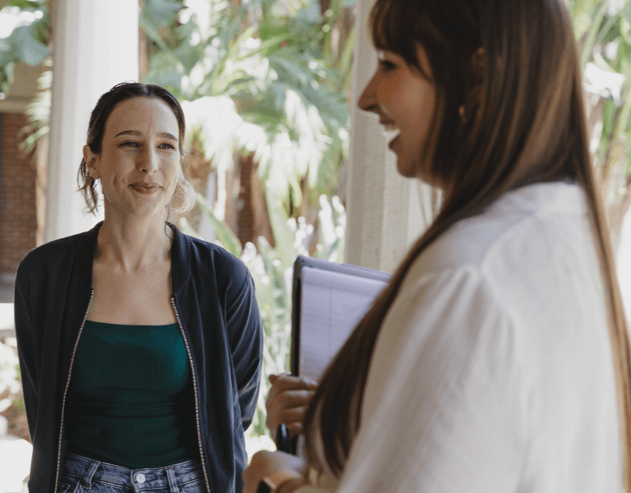 Two female Ontraport Certification graduates talking outside.