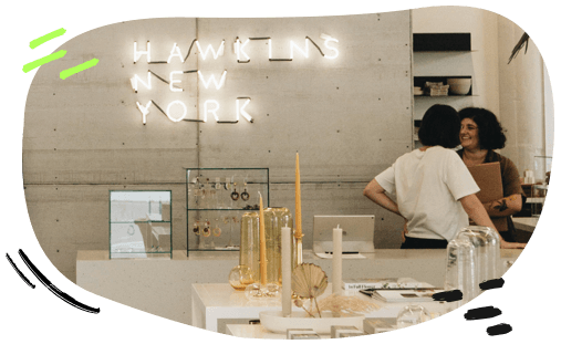 Two people speaking near a table with candles
