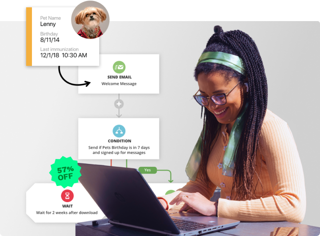 A woman smiling while on her laptop.