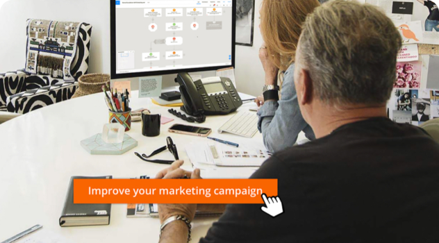 An image of a person sitting at a desk, looking at a computer, working in the Ontraport app