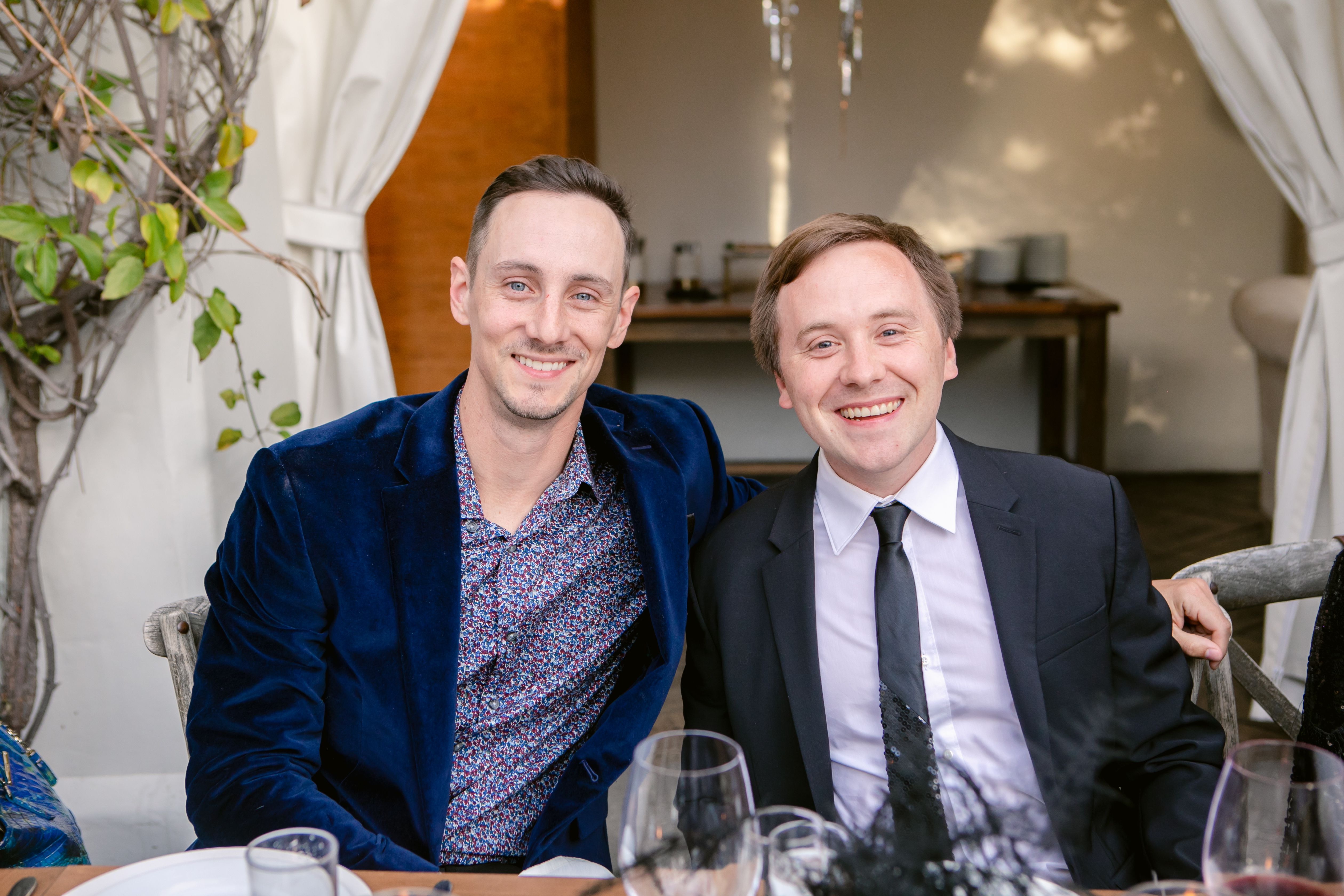 A woman sitting at a desk on a zoom meeting.