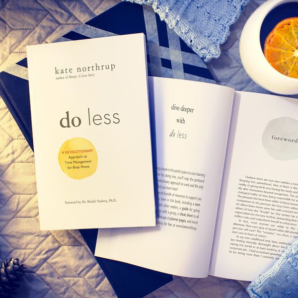 Image of Do Less Book Sitting on a countertop next to a drink