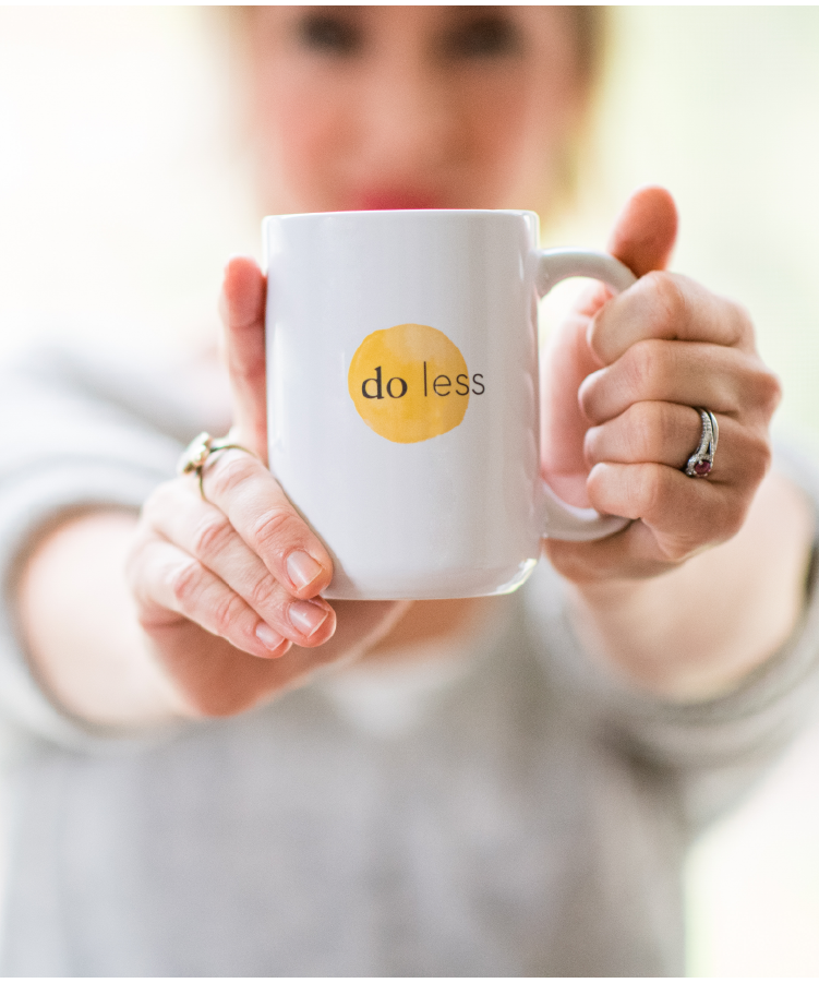 Kate holding a Do Less mug